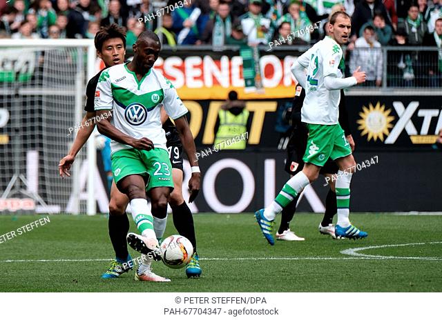 Wolfsburg's Joshua Guilavogui (front) and Augsburg's Ja-Cheol Koo in action during the German Bundesliga soccer match between VfL Wolfsburg and FC Augsburg at...