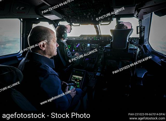23 October 2023, Brandenburg, Schönefeld: German Chancellor Olaf Scholz (SPD) sits in the cockpit of an Air Force Airbus A400M for the flight to Cologne-Wahn...