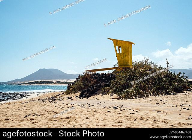 Scenic view of lifeguard yellow hut on the beach against sky