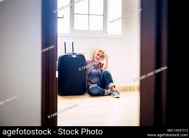 one woman sit down alone inside empty home with luggage - new house mortgage buyers people concept - real estate female lady relaxing indoor