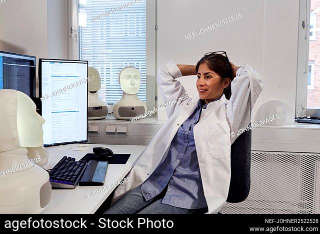Female engineer sitting at work station