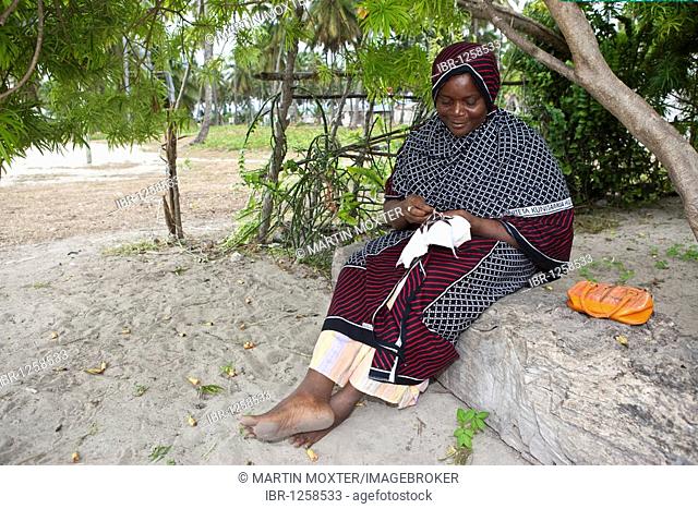An old woman embroidering a pattern, Jambiani, Zanzibar, Tanzania, Africa