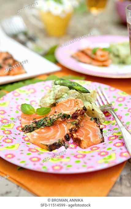 Marinated salmon with potato salad and green asparagus