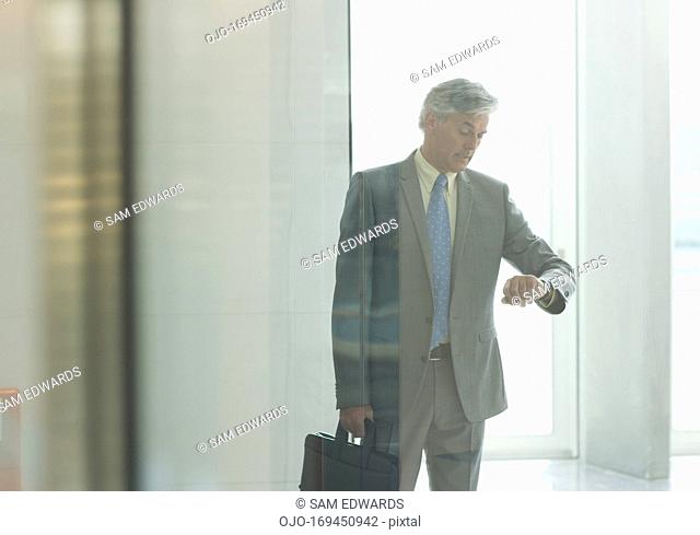 Businessman checking the time on wristwatch