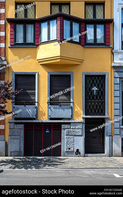 Ixelles, Brussels Capital Region, Belgium - 07 03 2022 - Yellow facade of a art deco house