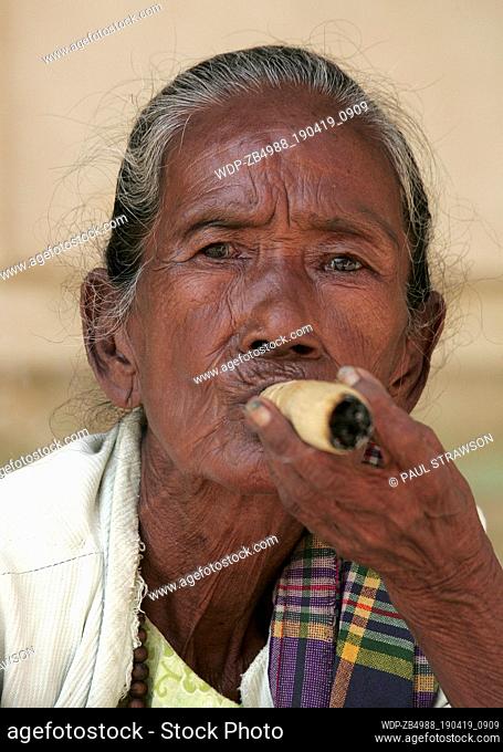 PORTRAIT OF AN ELDERLY WOMAN SMOKING A CHEROOT
