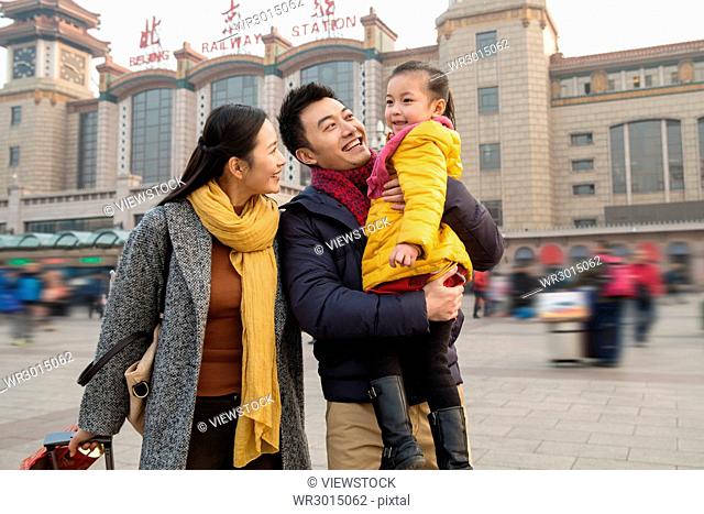 Happy family in front of the square