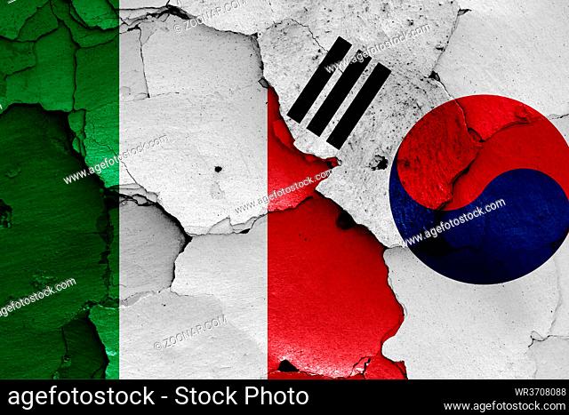 flags of Italy and South Korea painted on cracked wall