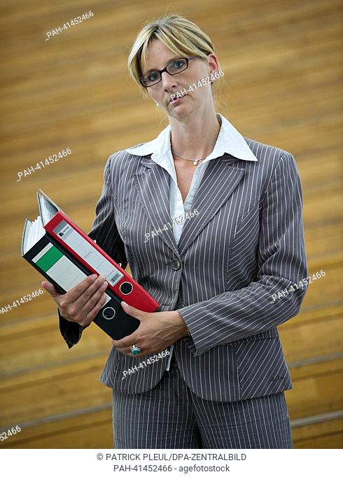 (ILLUSTRATION) An illustration shows a business woman with folders under her arms in Frankfurt Oder, Germany, 31 July 2013