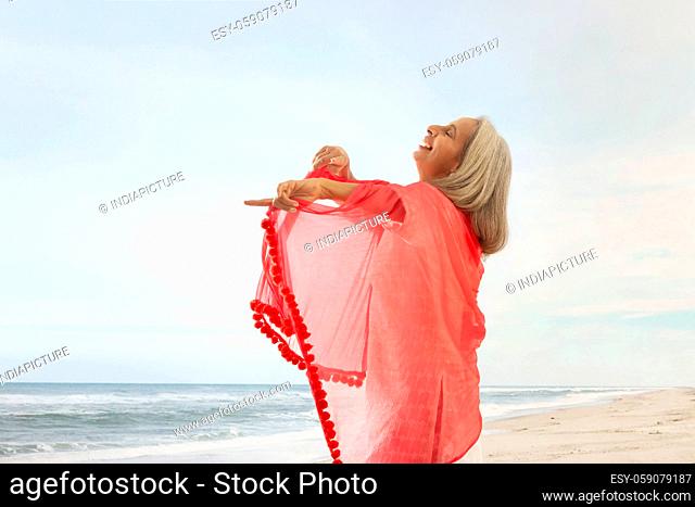 An old woman playing with her chunni on the beach