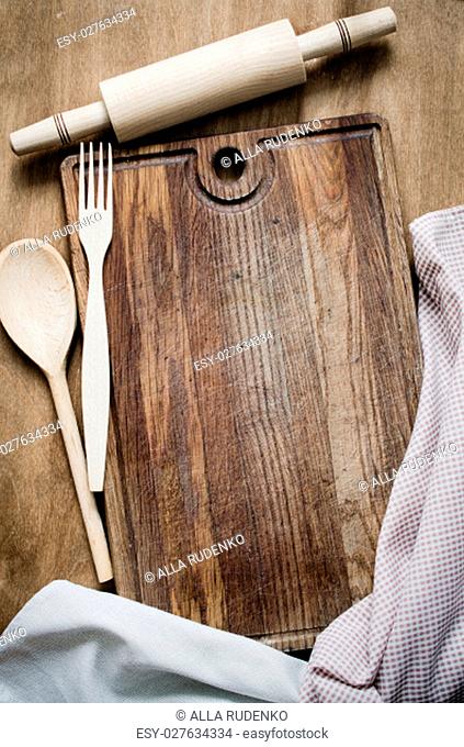 Kitchen Background: Rolling-pin with Kitchen Towel or Napkin on Wooden Board Over the Rustic Wooden Table. View From Above With Copy Space