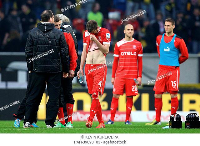 Duesseldorf's  Stelios Malezas (C) and hier teammates stand on the pitch after the Bundesliga soccer match between Fortuna Duesseldorf and Borussia Dortmund in...