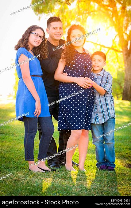 Hispanic Pregnant Family Portrait Outdoors