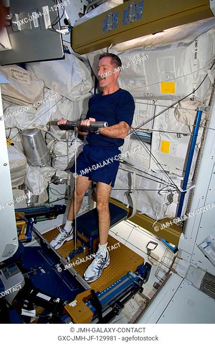 NASA astronaut Dan Burbank, Expedition 30 commander, uses the short bar for the advanced Resistive Exercise Device (aRED) equipment to perform upper body...