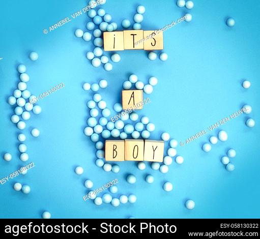 Its a Boy text written with wooden cubes with pastel blue background, Baby Shower or Nursery background Baby announcement. Flat lay, text space