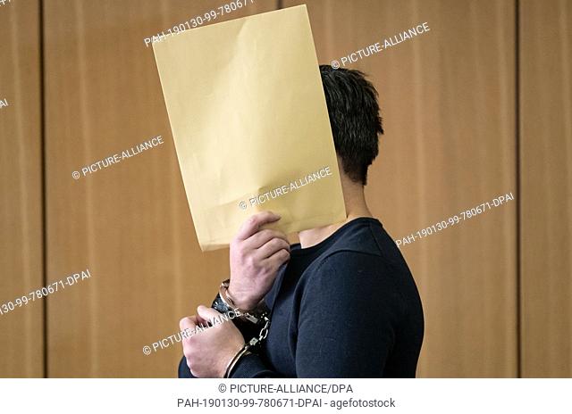 30 January 2019, Lower Saxony, Braunschweig: The defendant accused of murder is taken to the hall of the district court in Braunschweig
