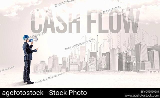 Young businessman with hard hat and CASH FLOW inscription, new business opportunity concept