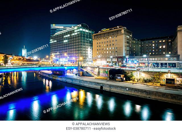 Buildings along the Danube Canal at night, in Vienna, Austria