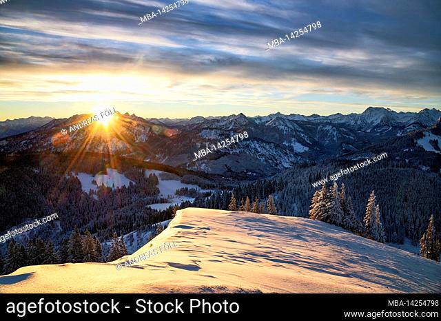 Beautiful sunrise on a cold winter day in the mountains. View from the Reuterwanne to the Tannheimer mountains. Bavaria, Germany, border area Tyrol, Austria