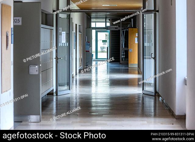15 March 2021, Bavaria, Regensburg: An empty corridor in a grammar school. More and more cities and districts in Bavaria are now again above the critical limit...