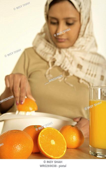 Arab lady prepares fresh orange juice