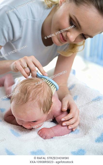 mum brushing babys head