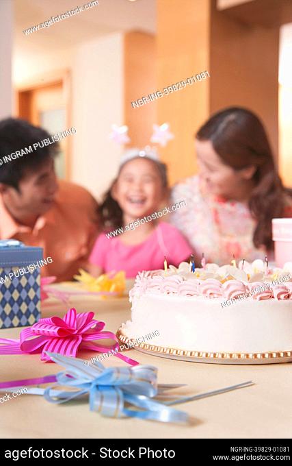 Family Celebrating Girl&rsquo;s Birthday - Focus On Birthday Cake