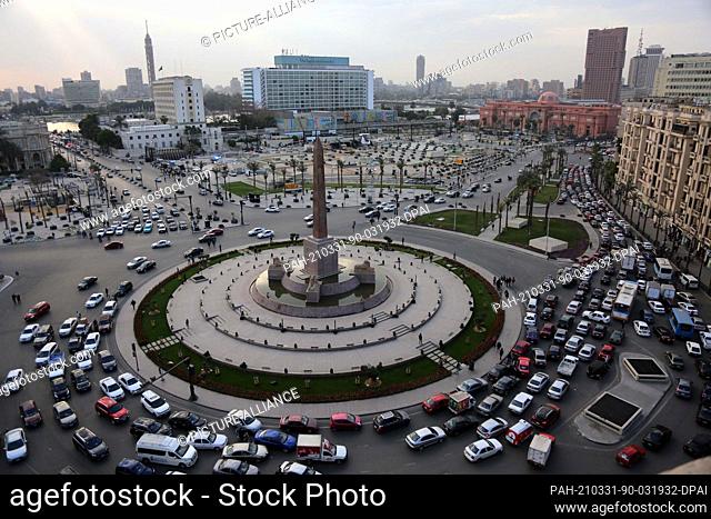 31 March 2021, Egypt, Cairo: A general view of the El-Tahrir Square with vehicles driving through the main roundabout adorned with the Obelisk of Ramses II and...