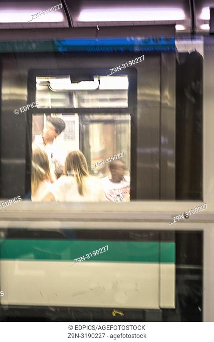 group of teenagers in an underground waggon, paris, ile de france, france