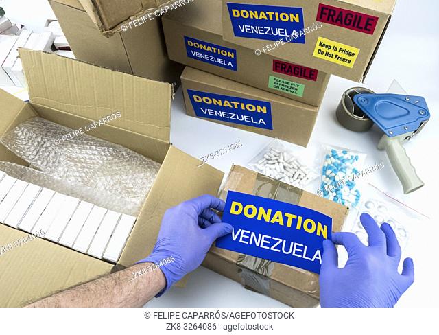 Humanitarian aid, nurse placing label donation medication to send Venezuela, conceptual image