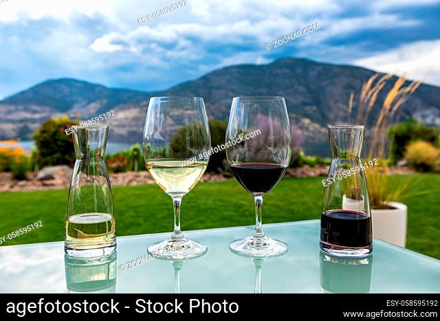 mini decanters and wine glasses filled with red and white wines selective focus, Canadian Okanagan Lake, Valley region, British Columbia BC Canada