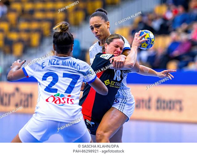 Germany's Anna Loerper (r) is attacked by France's Beatrice Edwige (back), with France's Estelle Nze Minko on the lect, during the Women's handball European...