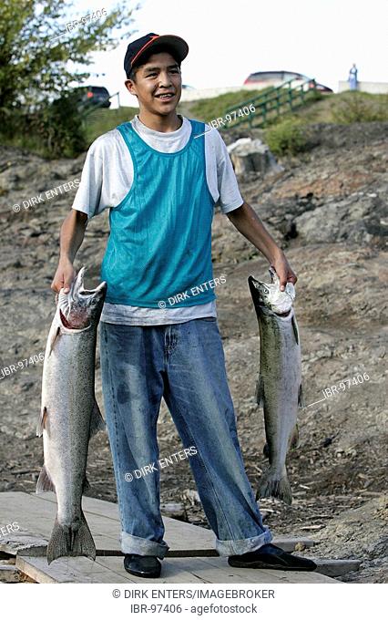 Indian with catched salmons at Bulkley River in Morristown, British Columbia, Canada
