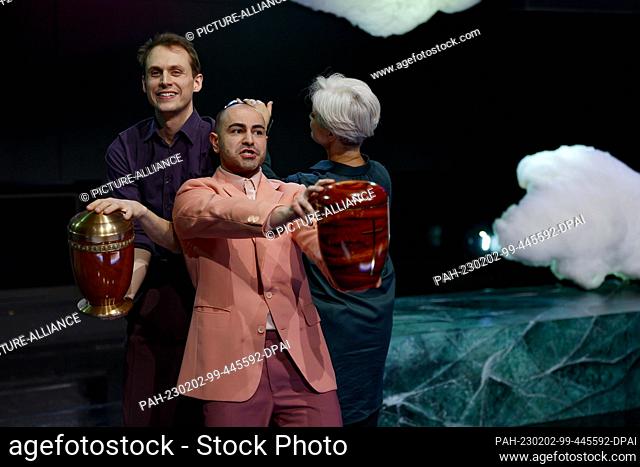 PRODUCTION - 31 January 2023, Bavaria, Nuremberg: Yascha Finn Nolting (l-r), Aydin Aydin and Adeline Schebesch praise various urns in this scene of the play...
