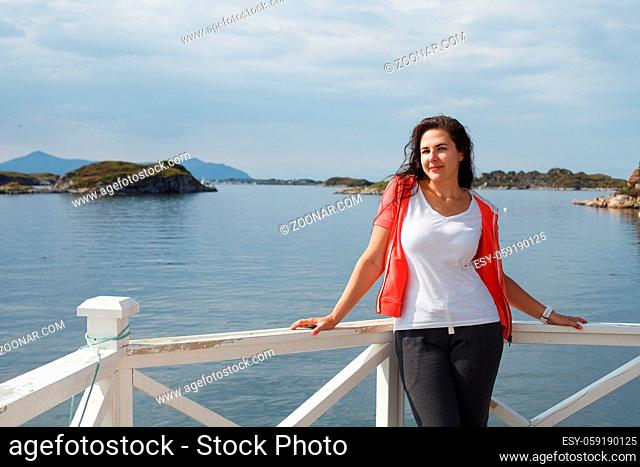 Young woman against beautiful view on norwegian fjords. outdoor shot in Norway. copy space
