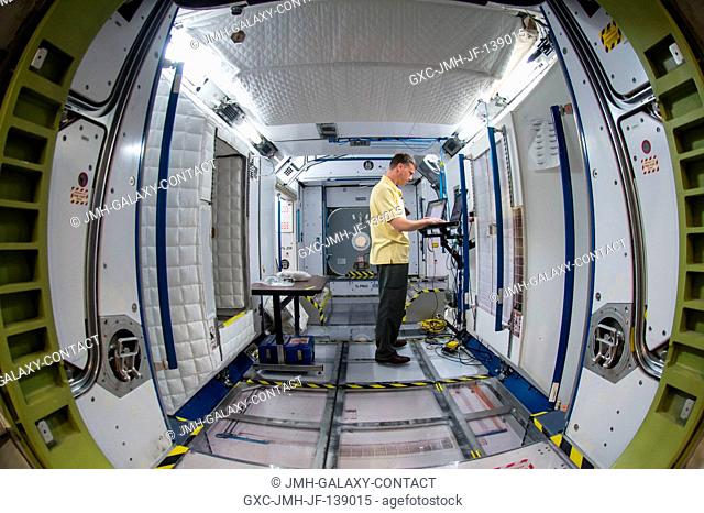 NASA astronaut Reid Wiseman, flight engineer, participates in routine operations training for Expedition 41 in the Space Vehicle Mockup Facility at the Johnson...