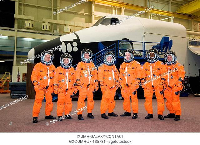 The STS-122 crewmembers, attired in training versions of their shuttle launch and entry suits, pose for a crew photo prior to a training session in the Space...