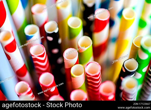 Variety of paper stripped cocktail straws as a summer background