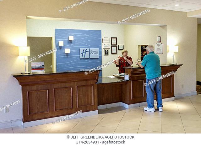 Florida, FL, New Port Richey, Holiday Inn Express, motel, hotel, front desk, reservations, counter, woman, employee, helping, guest, man, service