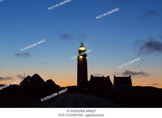 Eierland Lighthouse in the dunes silhouetted against sunset on the northernmost tip of the Dutch island of Texel, Noord-Holland, the Netherlands