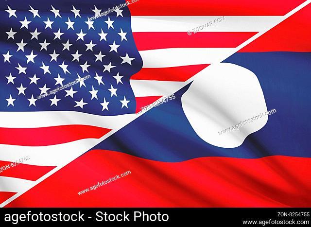 Flags of USA and Lao People's Democratic Republic blowing in the wind. Part of a series