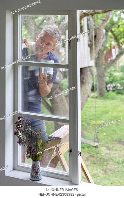 Man painting window