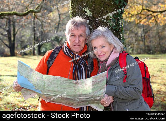 Senior couple with map on a hiking day