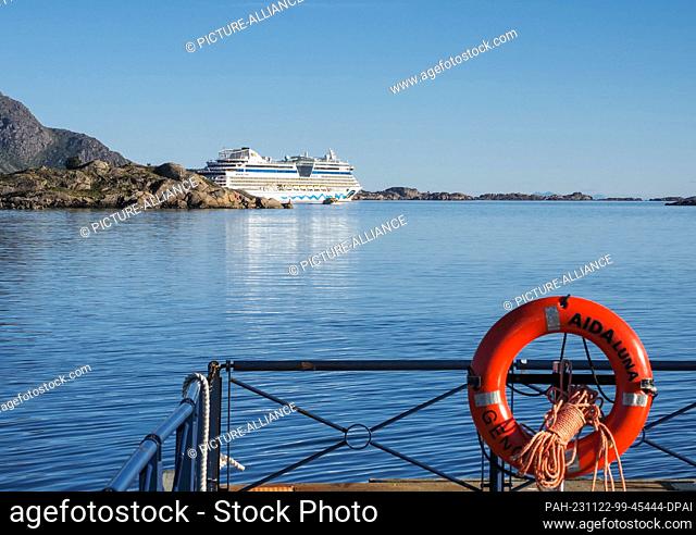 26 August 2023, Norway, Leknes: The cruise ship AIDAluna is moored in the bay behind rocks near the port of Leknes. Photo: Soeren Stache/dpa