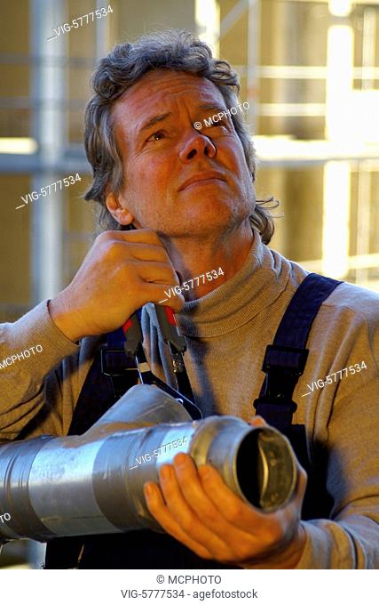 Ein Installateur auf einer Baustelle schaut etwas besorgt, Hamburg 2006 - Hamburg, Germany, 27/12/2006