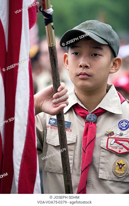 Asian boyscout display US Flag at solemn 2014 Memorial Day Event, Los Angeles National Cemetery, California, USA