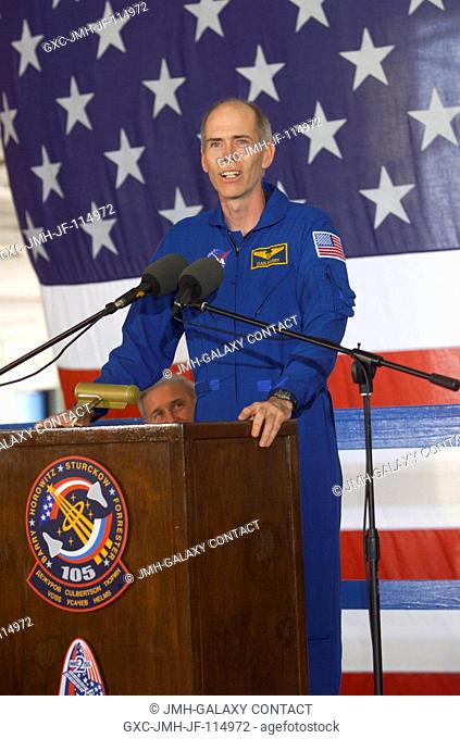 Daniel T. Barry, STS-105 mission specialist, speaks from the podium in Hangar 990 at Ellington Field during the STS-105 and Expedition Two crew return...