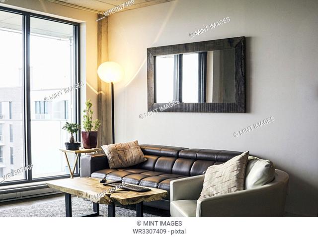 Sofa and armchair near livingroom window