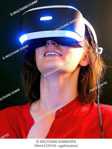 A woman tests a Sony Playstation during a press conference at the International Electronics fair 'IFA', in Berlin, Germany, 3 September 2015