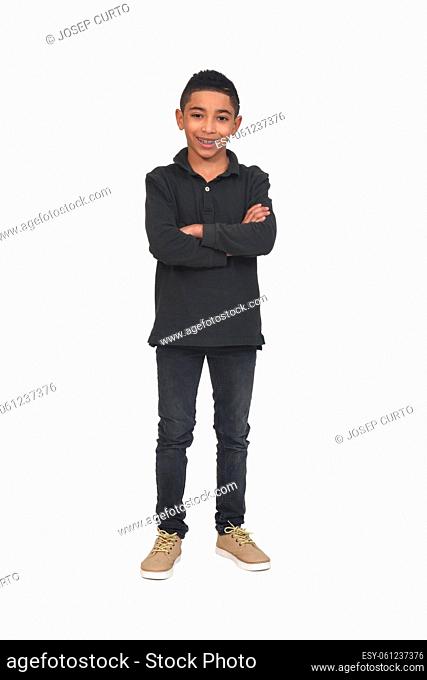 portrait of boy with arms crossed looking at camera on white background